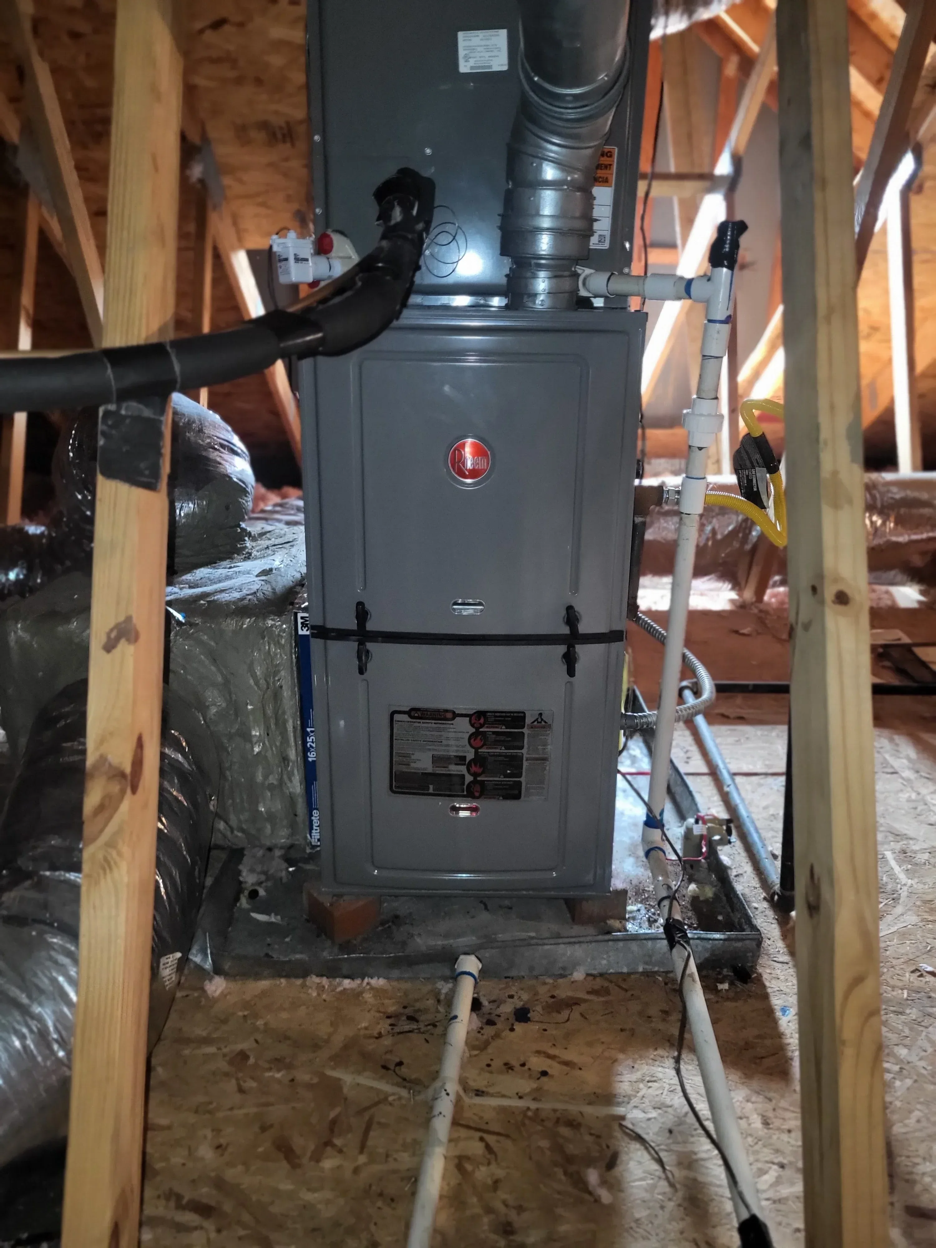 Electrical panel with HVAC ductwork and piping installation in basement framing