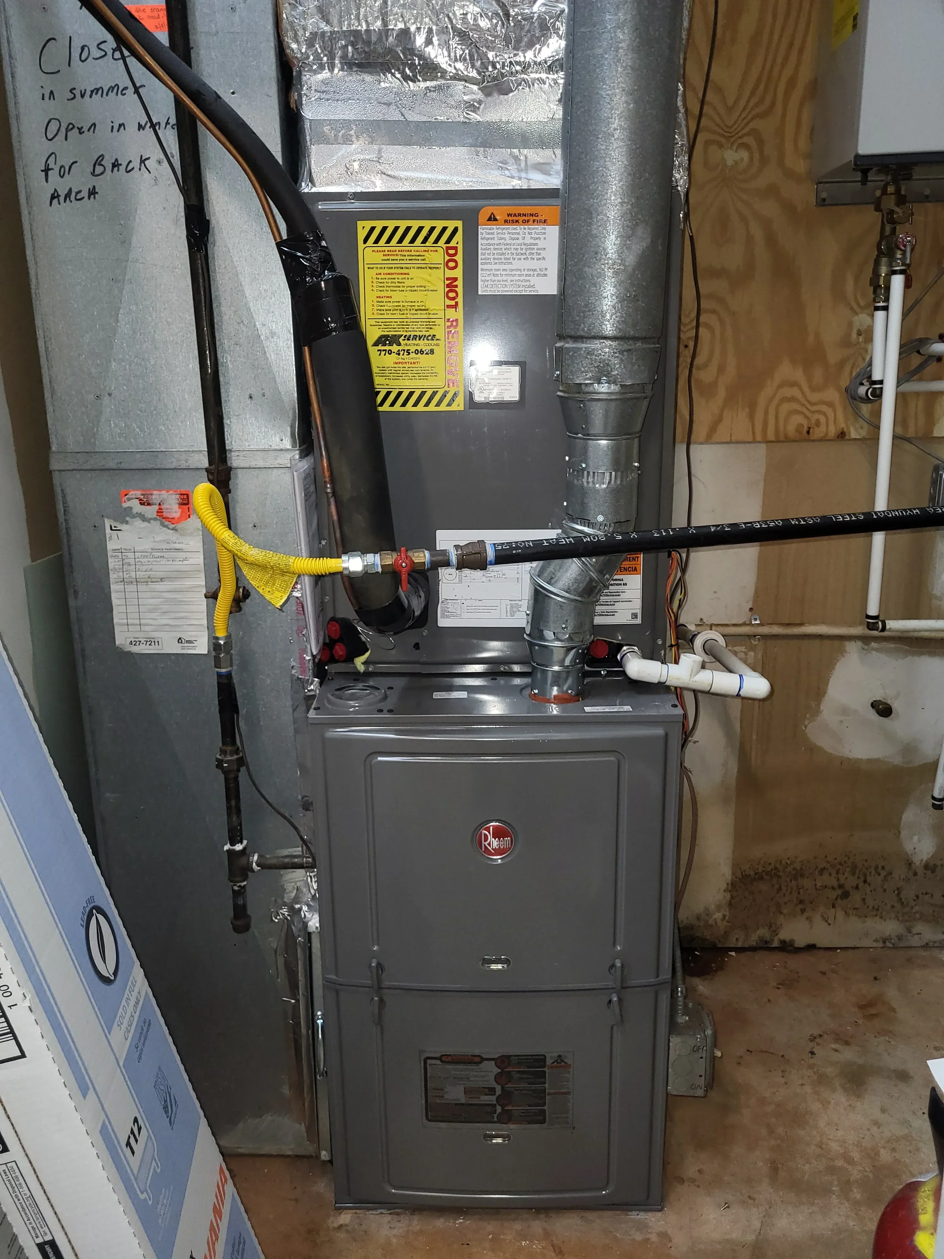 New gas furnace installation with insulated ductwork, safety disconnect, and yellow gas line connections