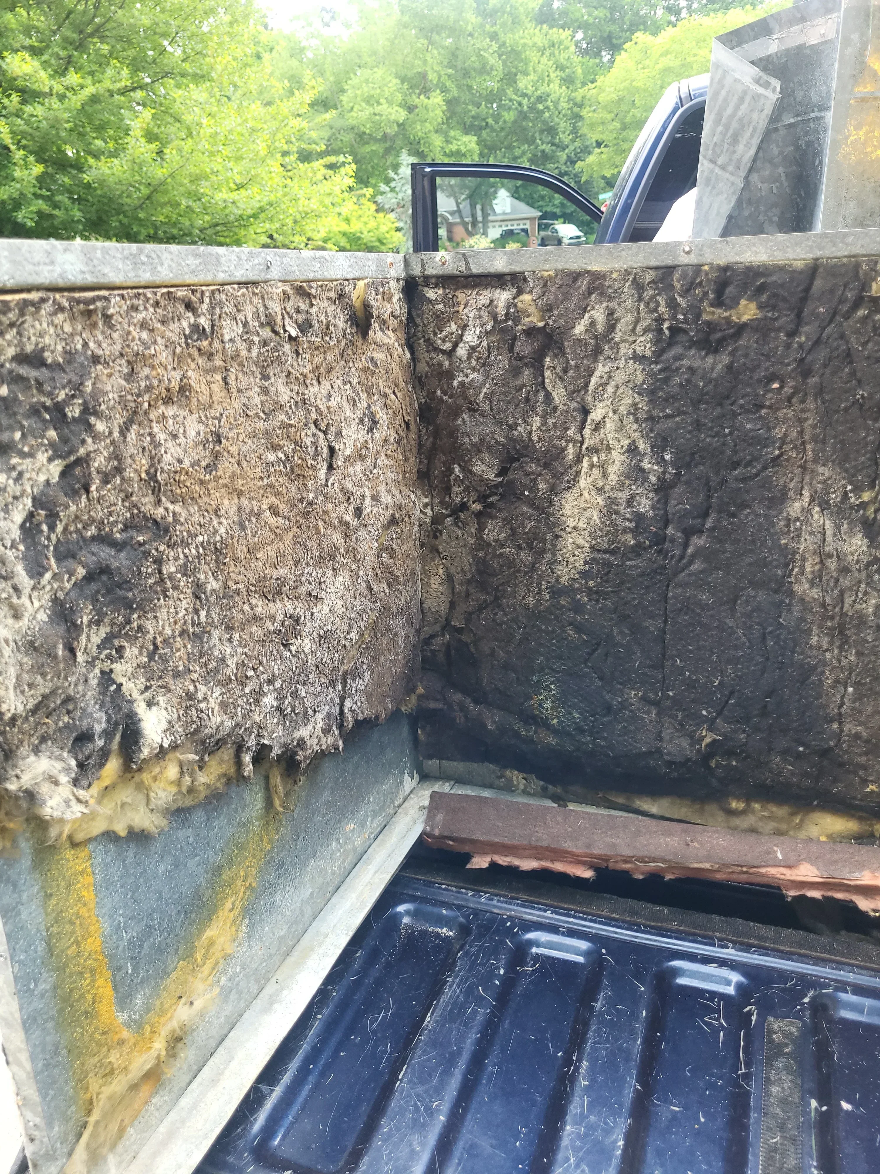 Basement HVAC ductwork with dust buildup and metal piping installation